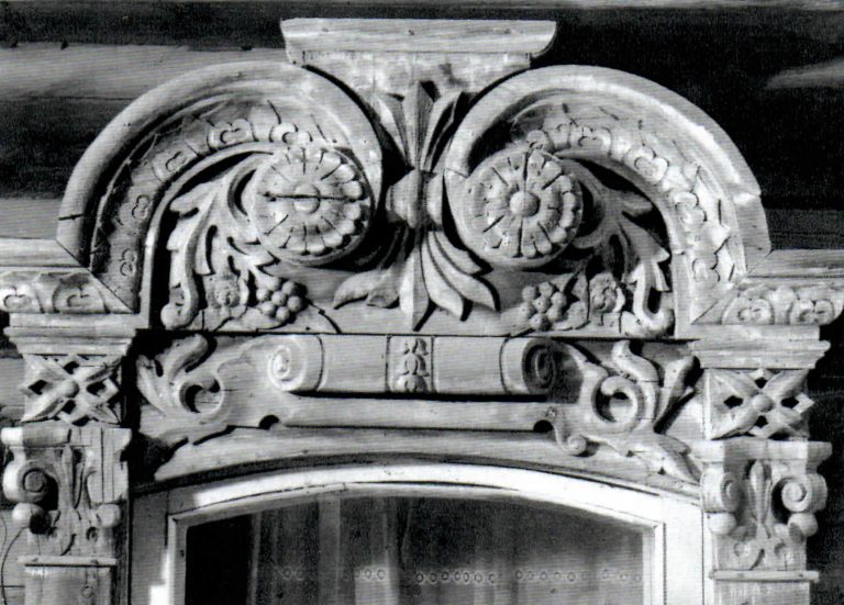 Window frame decorated with carved roses and grapes