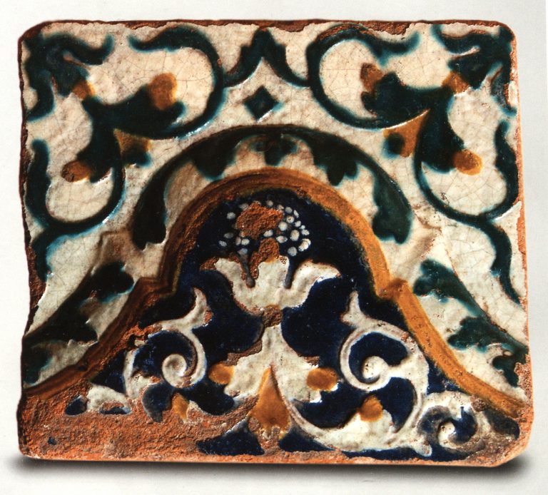 Multicoloured wall tile with floral relief ornament. <br/>First half of 18th century