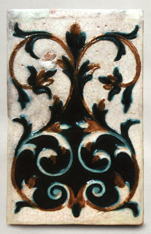 Multicoloured wall tile with floral  relief ornament