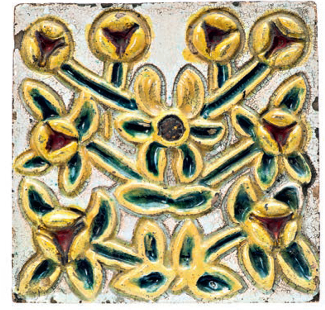 Stove tile with embossed image of yellow stylized flowers