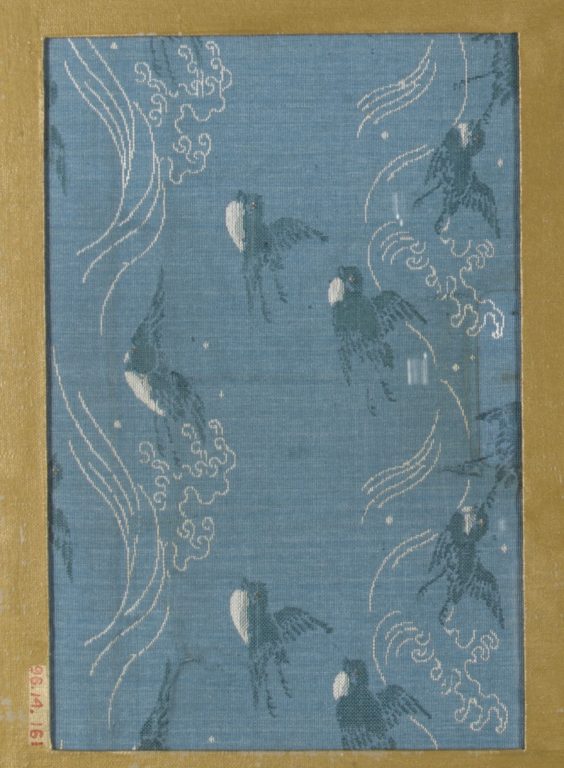 Textile fragment with repeating pattern of waves and birds in flight